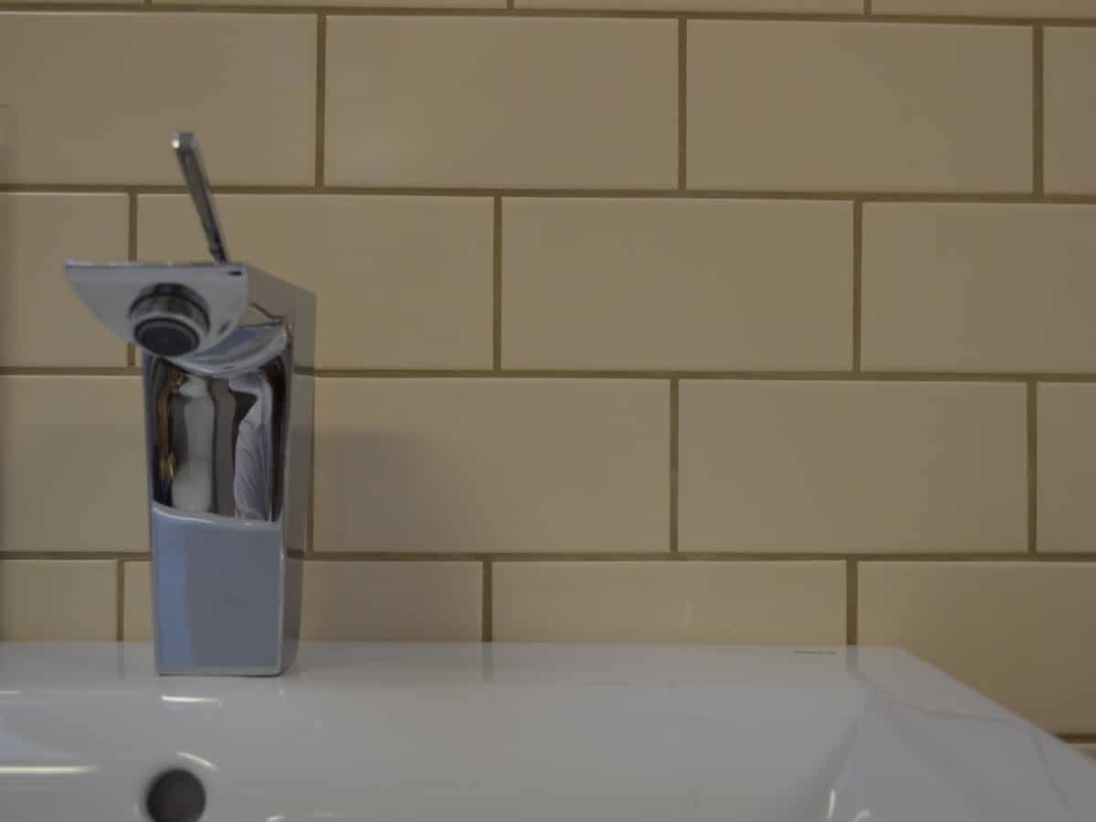 cream splash back featuring a modern design tap