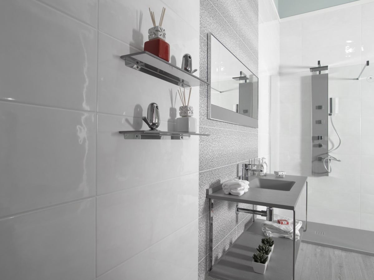 up to date bathroom with a think minimalist basin and unique grey decor tile