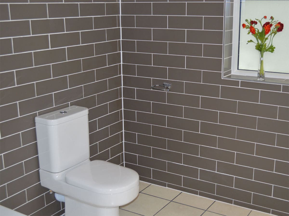 close coupled toilet within a fully tiled bathroom
