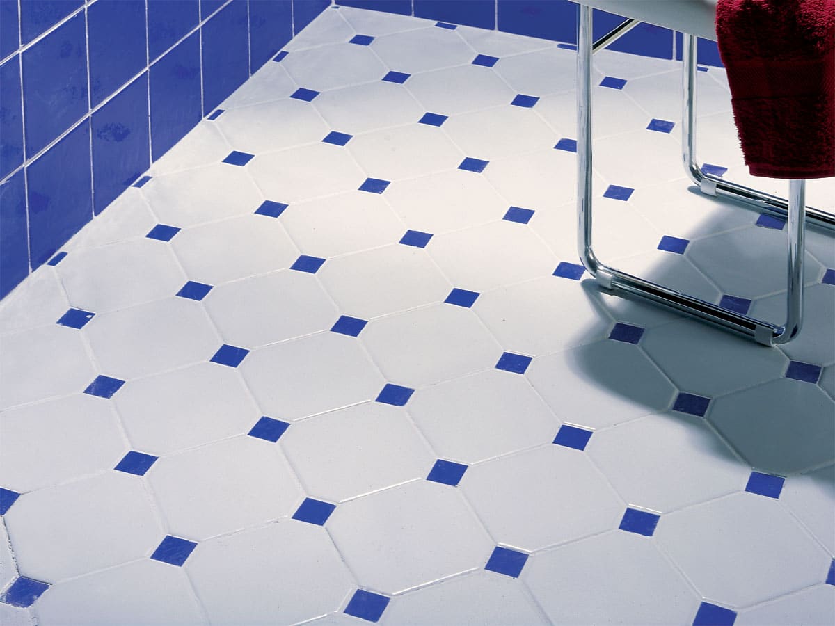 white and blue octagon floor tiles in a blue bathroom setting