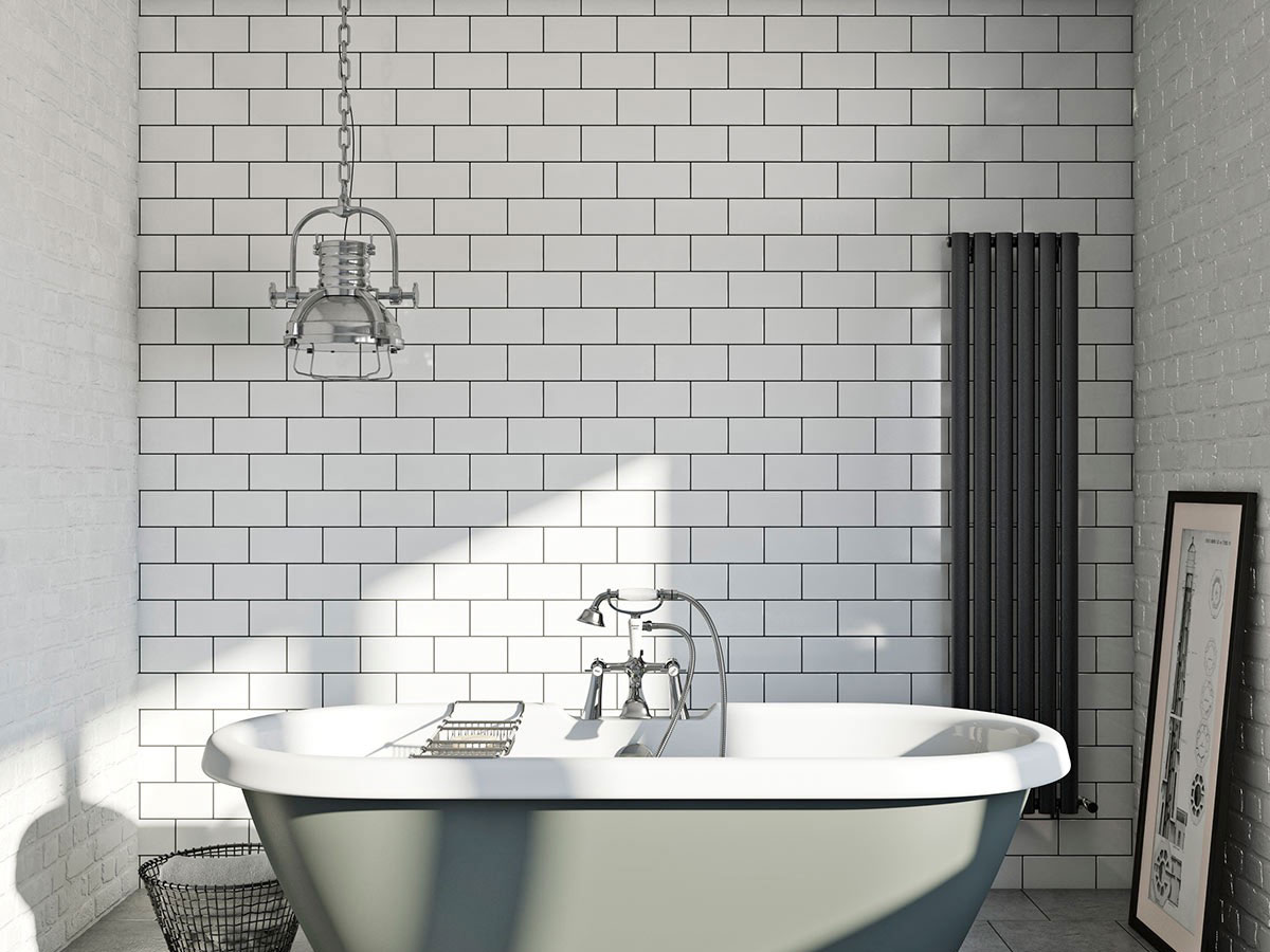 free standing traditional bath with white brick effect tiles