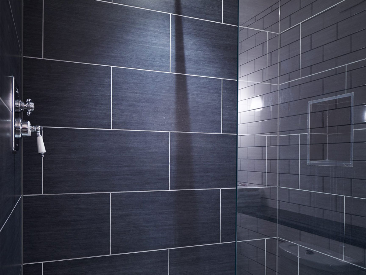 black tiles within a walk in shower