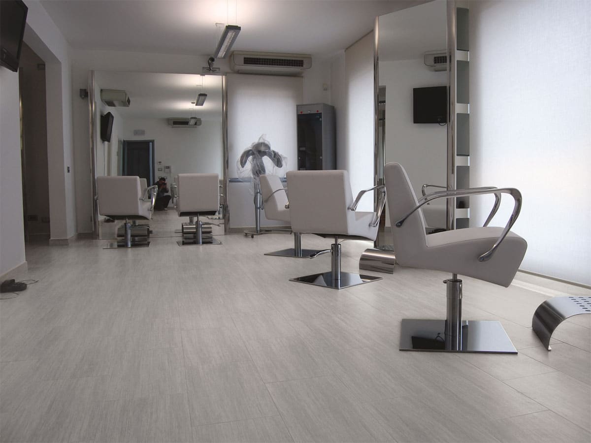 modern saloon with large mirros and white swivelling chairs