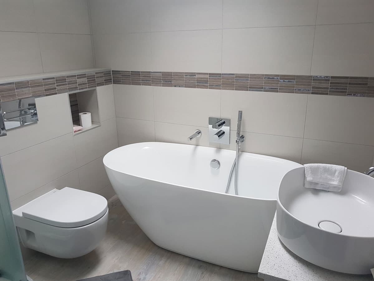 modern and functional bathroom with a freestanding bath & wall hung wc