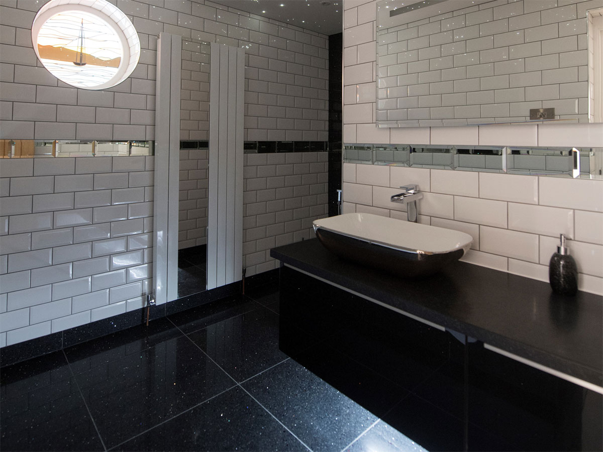 beautiful stylish bathroom with white bevelled tiles and freestanding basin