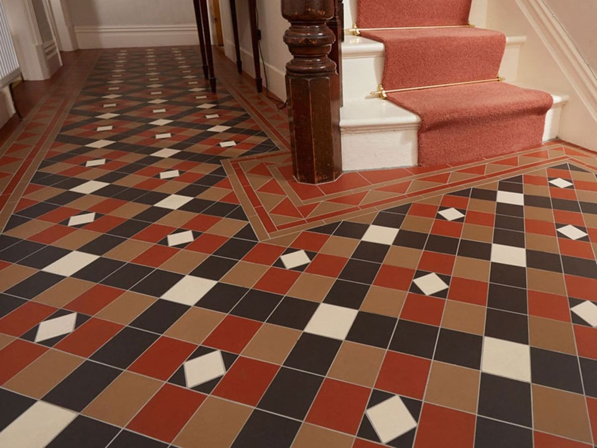 victorian floor tiles in a hallway using red, brown and black colours