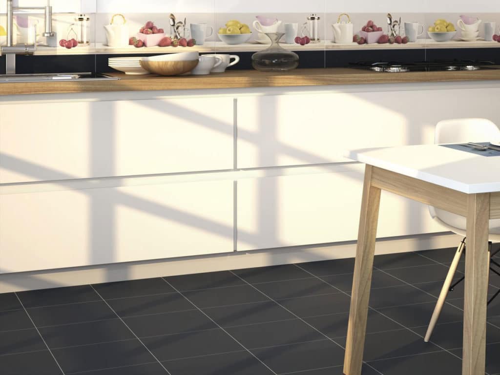 designer kitchen area with contrasting white units and black floor tiles