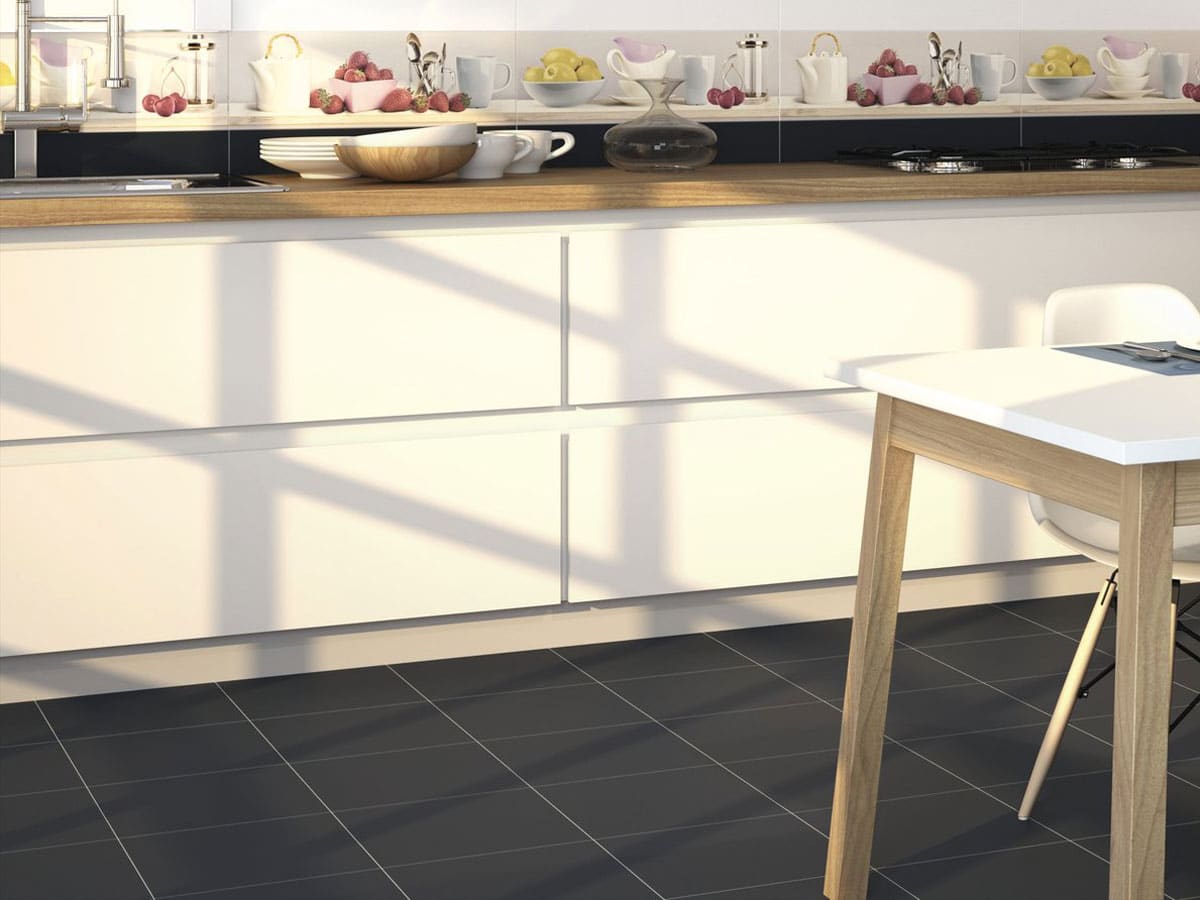 designer kitchen area with contrasting white units and black floor tiles